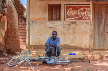 African man fixes a bicycle flat tire