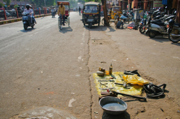 Repairng bicycles on the sidewalk in Jaipur.
