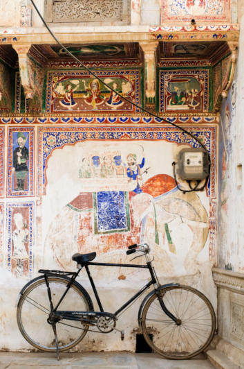 A bicycle is parked against a wall in Shekhawati, India