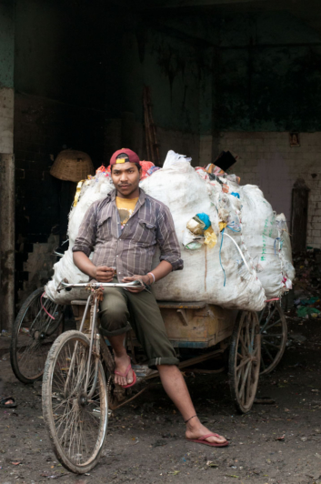 A rickshaw carries recycled objects in India.