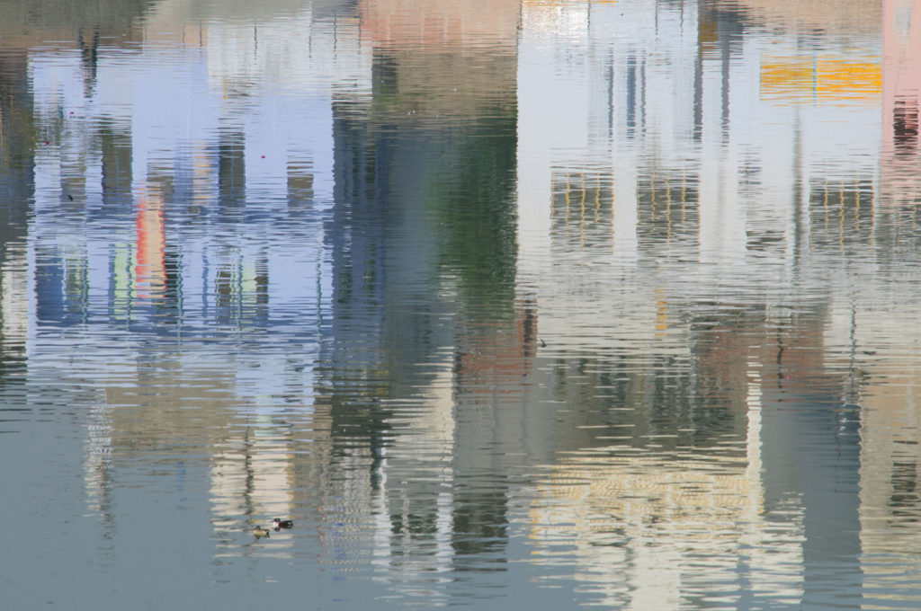 The buildings of Pushkar are mirrored in the lake.