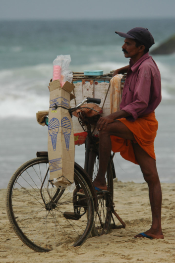 A cycling ice cream salesman in Kerala, India.