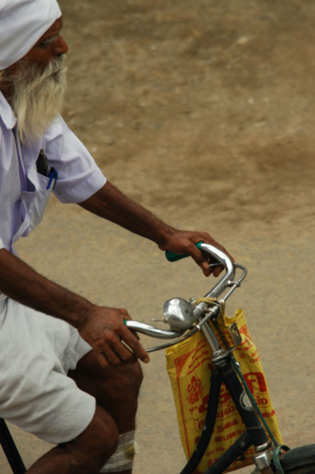 An elderly Sikh pedals his bicycle in India.
