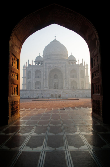 The taj mahal viewed from inside a gateway