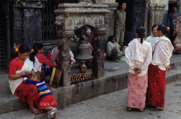 Women visit a temple in Kathmandu.
