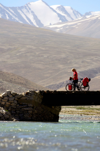 Pushing a bike over a bridge in Tajikistan.