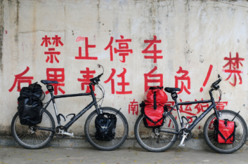 Touring bicycles are leaned against a wall in China