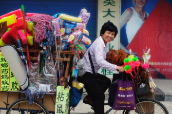 Chinese cycling broom saleswoman