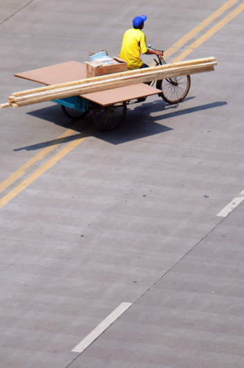 a cargo bike carries building materials.