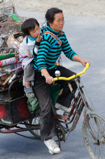 Bike culture China a women cycles with her child