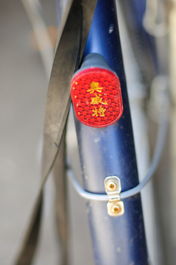 a blue Chinese bicycle fender with a reflector
