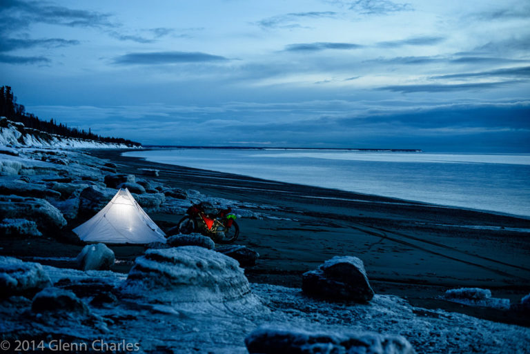 Glen Charles bike camping on a beach in Alaska.