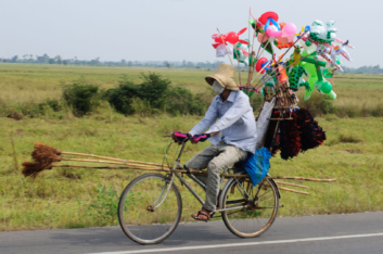 Cambodia bike culture a cycling broom salesman