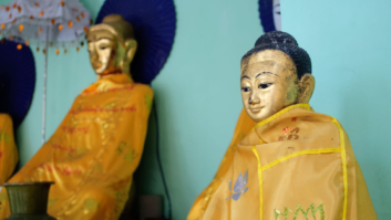 Two small golden Buddha statues.