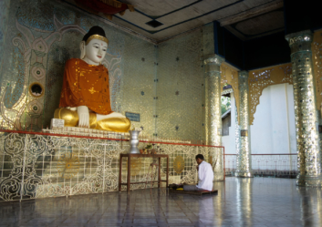A large Buddha statue in the Shwedagon pagoda.