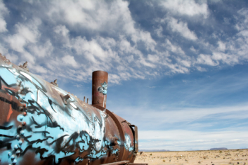 A rusted train engine with graffiti on it in Uyuni, Bolivia.