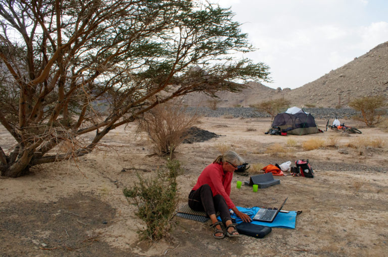 Starting up the computer while wild camping in Oman.