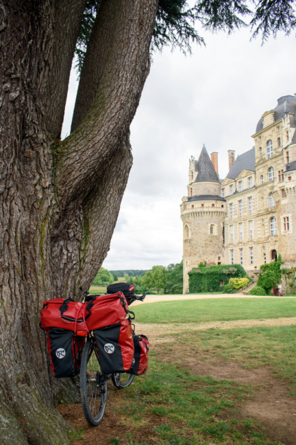 A touring bike is parked against a tree in the Loire region of France.