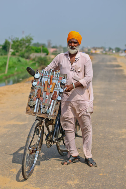 A cycling Sikh lock salesman in North India.