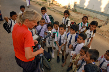 Cyclist meets Indian school kids.