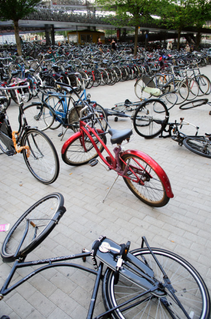 Bicycles are chaotically parked in front of Amsterdam Central Station.