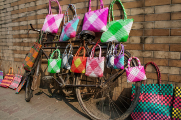 Shopping bags are hung on a bicycle in Bangladesh.