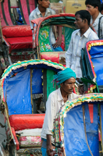 A rickshaw chauffer waits for traffic to start again in Dhaka.