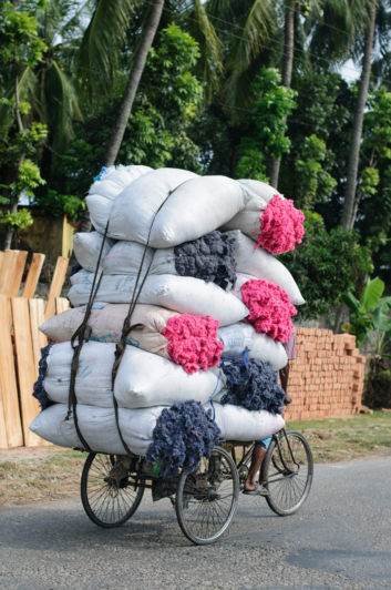 Coloful stuffing is piled on top of a rickshaw in Bangladesh.