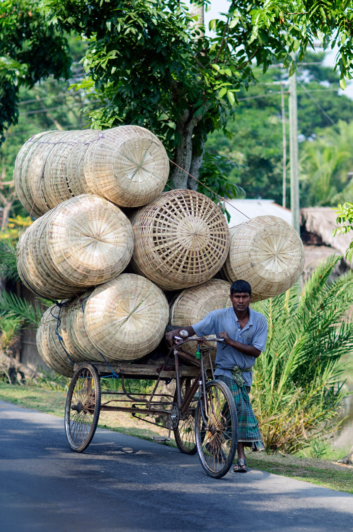 A rickshaw loaded with baskets.
