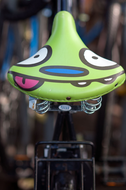 A bicycle seat with a goofy face printed on it in Amsterdam.