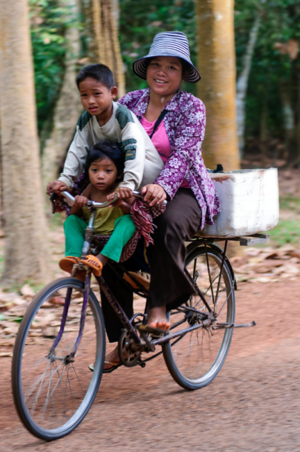 A Cambodian family rides a single bike.